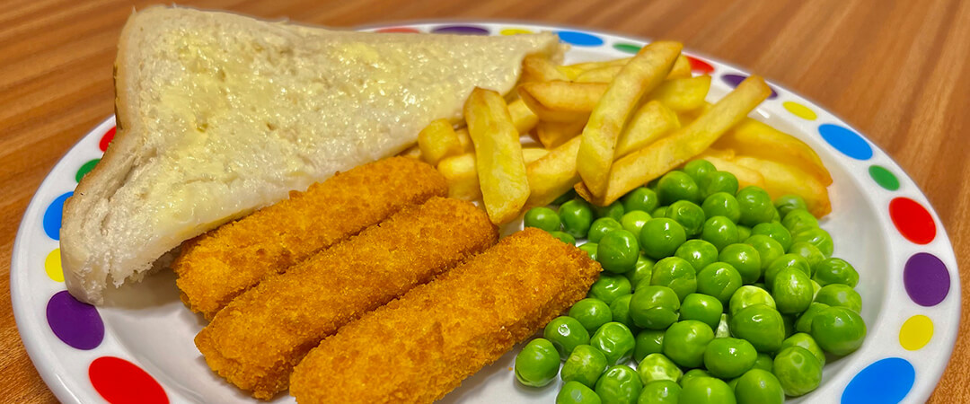 Quorn fishless fingers (Ve) served with chips, peas and bread and spread