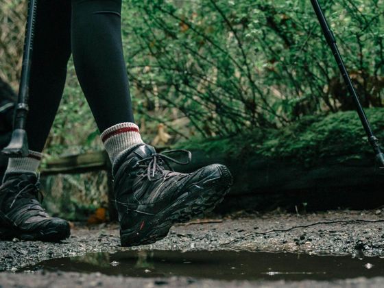 Low angle shot of a person wearing hiking shoes (Pexels - PNW Production)