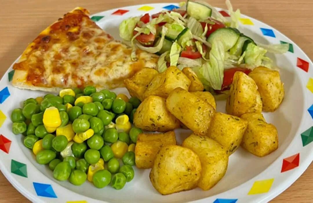 Cheese and tomato pizza served with diced potatoes, salad, peas and sweetcorn