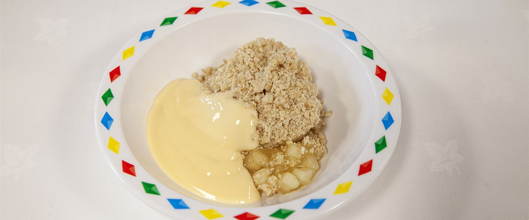Fruit crumble served with custard