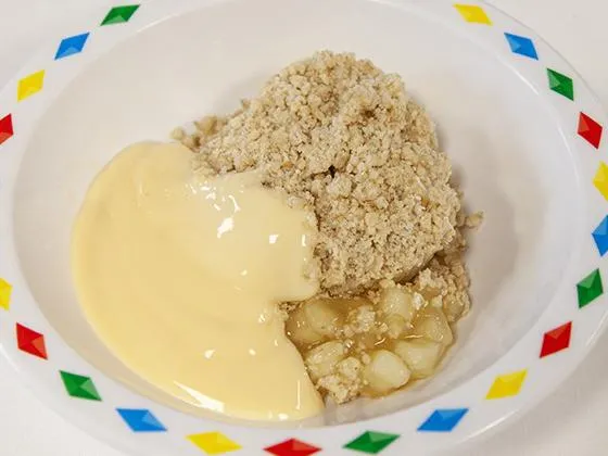 Fruit crumble served with custard