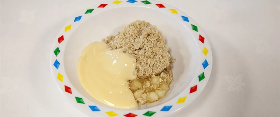 Fruit crumble served with custard