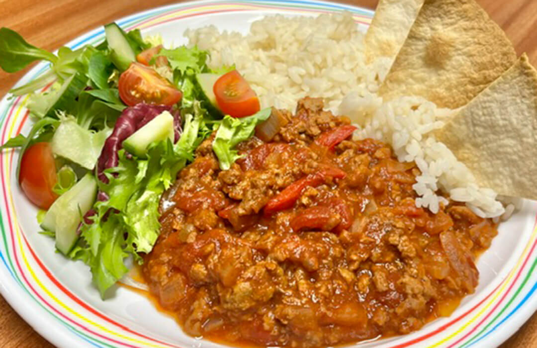  Homemade BBQ Quorn (V) served with vegetable rice, tortilla chips, peas or mixed vegetables
