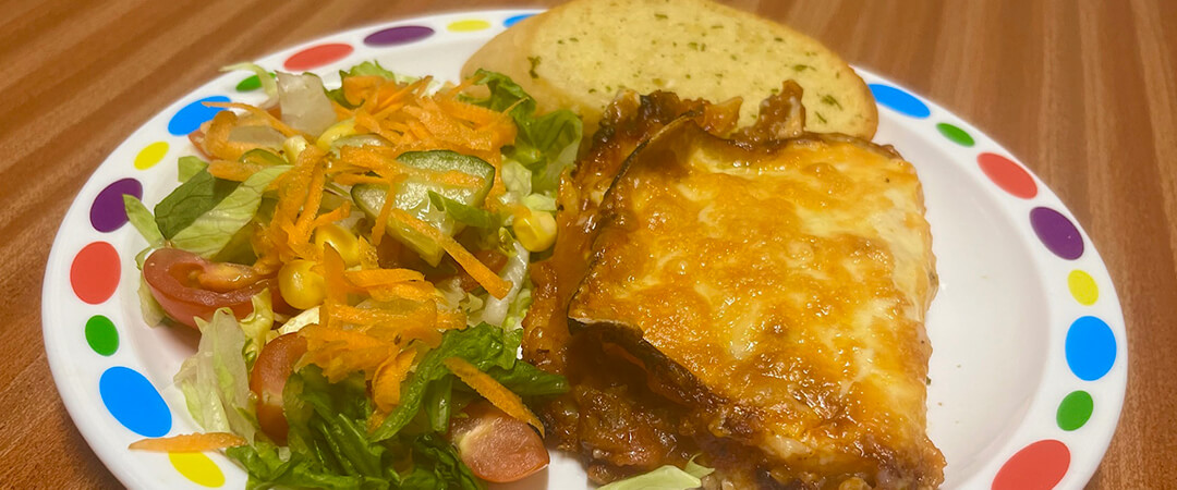 Quorn and spinach lasagne (v) served with garlic bread, vegetables or salad