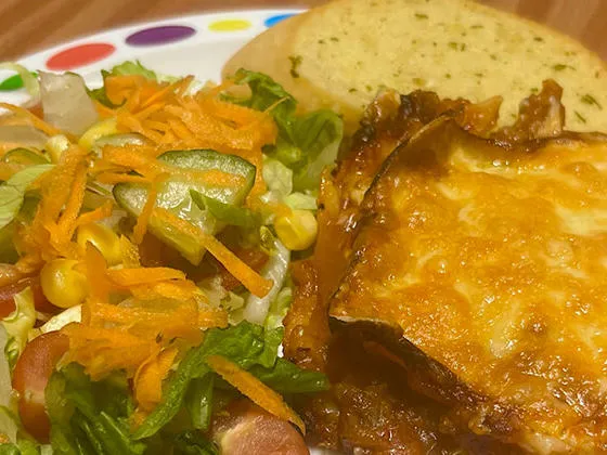 Quorn and spinach lasagne (v) served with garlic bread, vegetables or salad