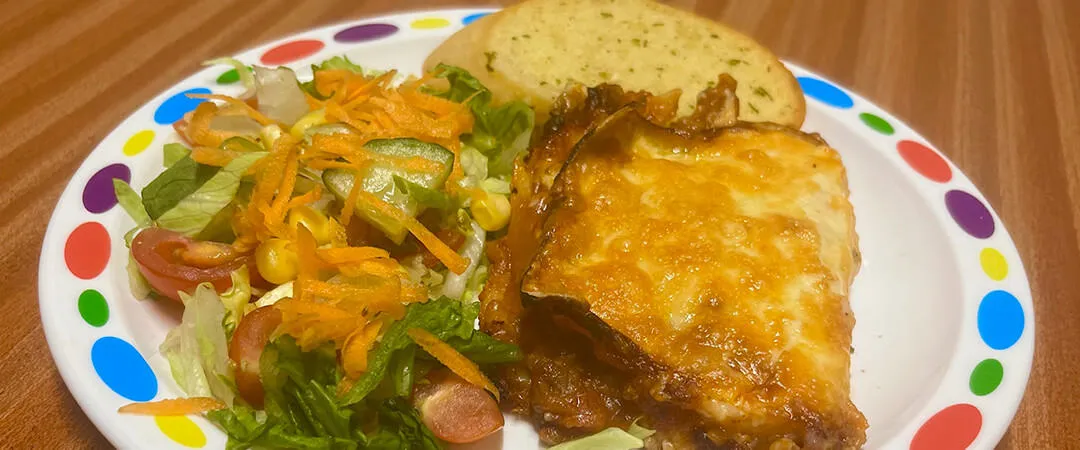 Quorn and spinach lasagne (v) served with garlic bread, vegetables or salad