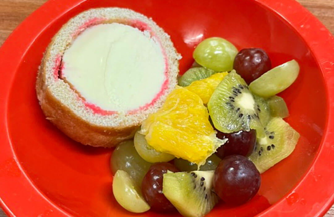 Raspberry and vanilla arctic roll with fruit selection