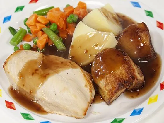Roast chicken with stuffing, roast and boiled potatoes, veg selection and gravy