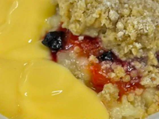 Fruit crumble served with custard