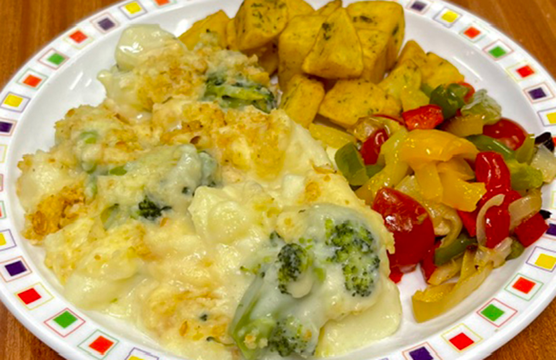 Broccoli and potato bake with a garlic crumb (V) served with Mediterranean roasted vegetables