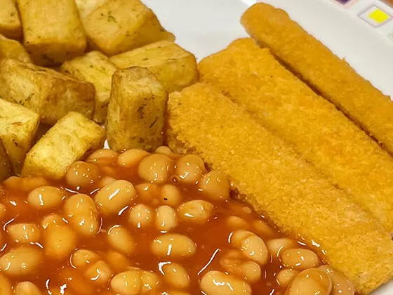Cod fish fingers served with herby diced potatoes, baked beans and bread and spread