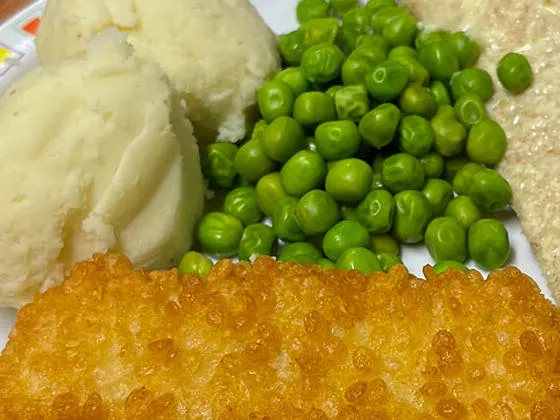 Double bubble salmon fillet served with mash, peas and garlic bread