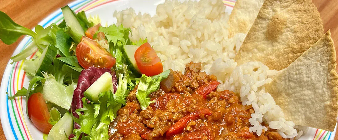 Homemade BBQ Quorn served with rice, tortilla chips and salad