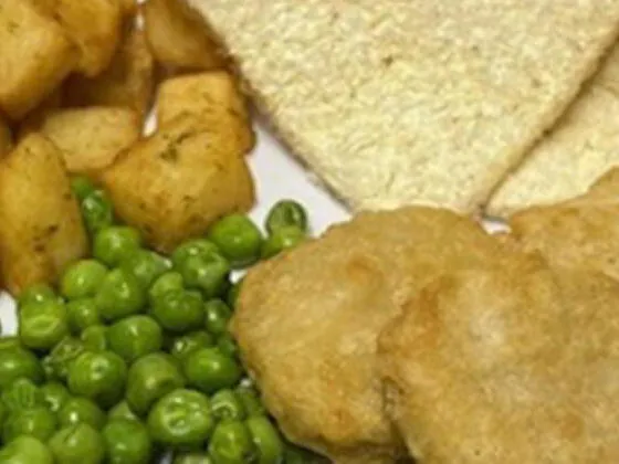 Quorn nuggets (Ve) served with herby diced potatoes, peas, bread and spread