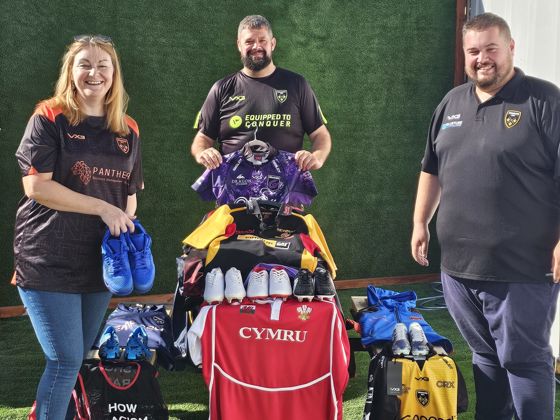 Councillor Fiona Cross pictured with members of Dragons RFC holding donated sports kit.