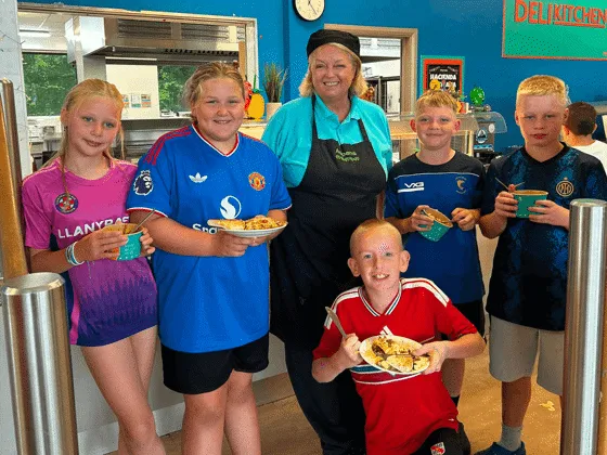 Children enjoying lunch at the moving up camp