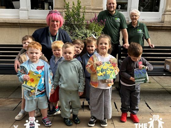 Children from Osbourne Lodge Nursery planting bulbs in the town centre