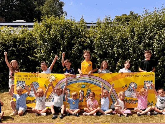 Pupils at Ponthir Church in Wales Primary School holding the #NotInMissOut banner