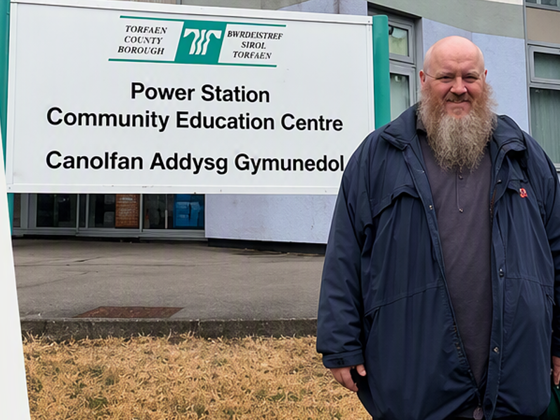 Anthony standing out side the power station smiling