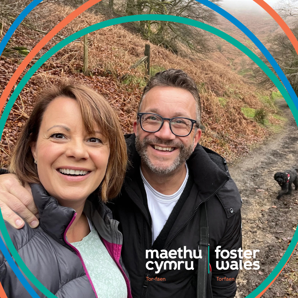 Darren and Emma, two foster carers from Torfaen, out on a walk with their dog